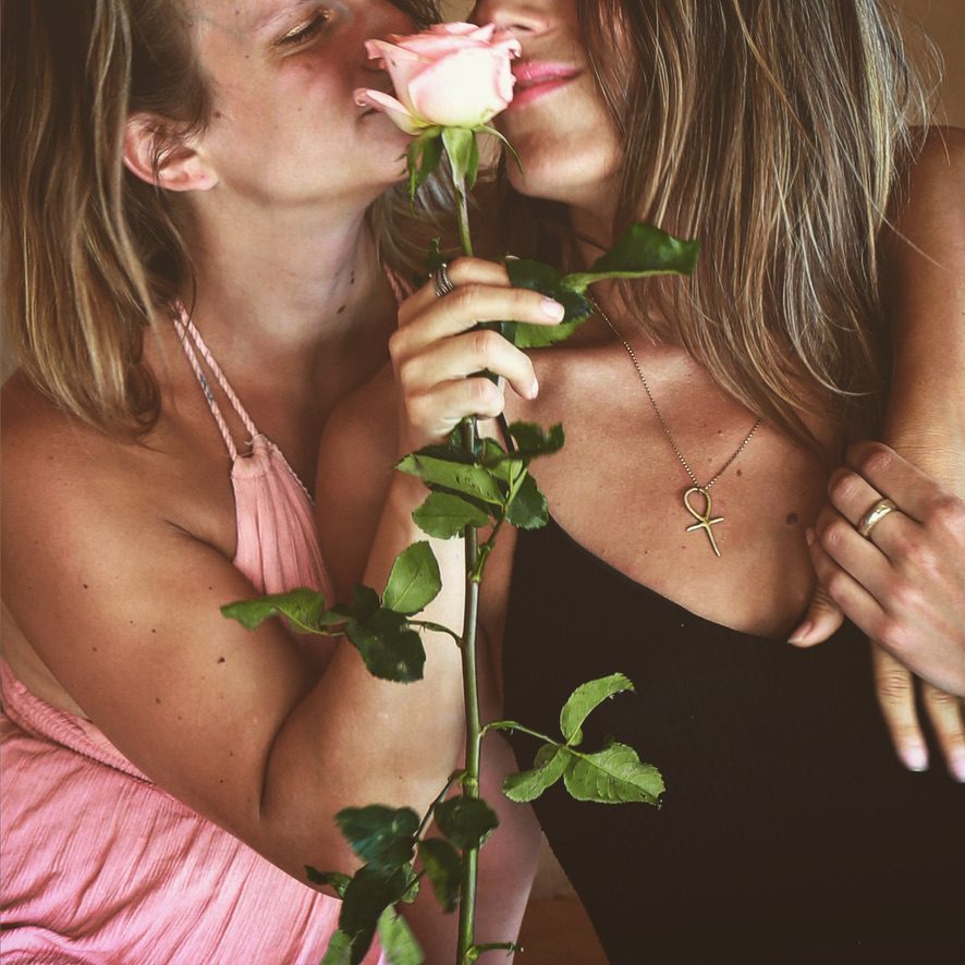 Two women sharing a rose